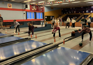 Dziewczynki na torach rzucają kulami.