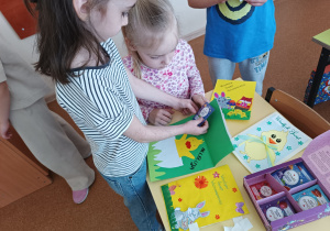 Dzieci z grupy "0" pracują nad kartkami z życzeniami dla seniorów