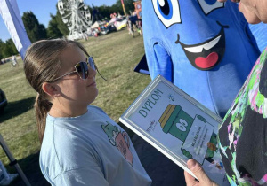 Maja odbiera dyplom z rąk organizatora