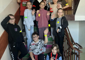 Klasa Vb stoi na schodach z odblaskami.